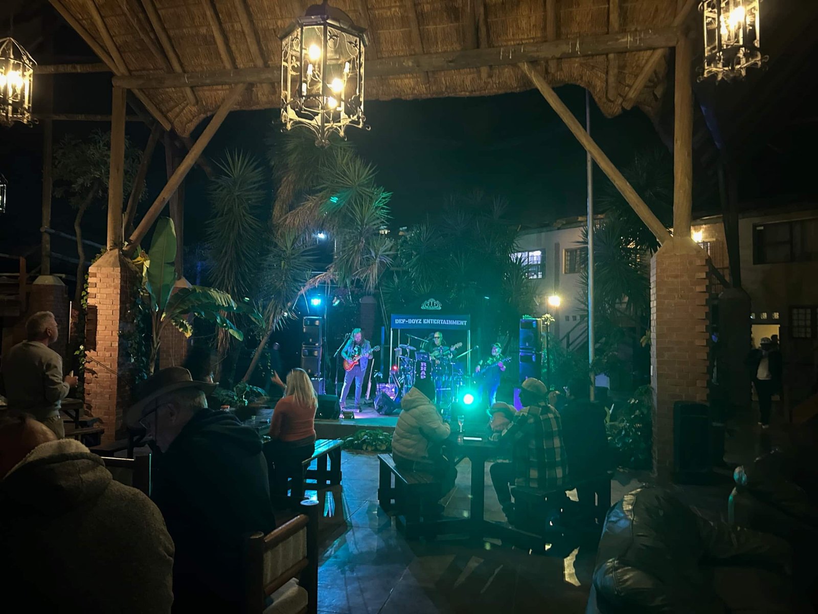 Live band playing in the courtyard at night at Sparrow Hawk Lodge