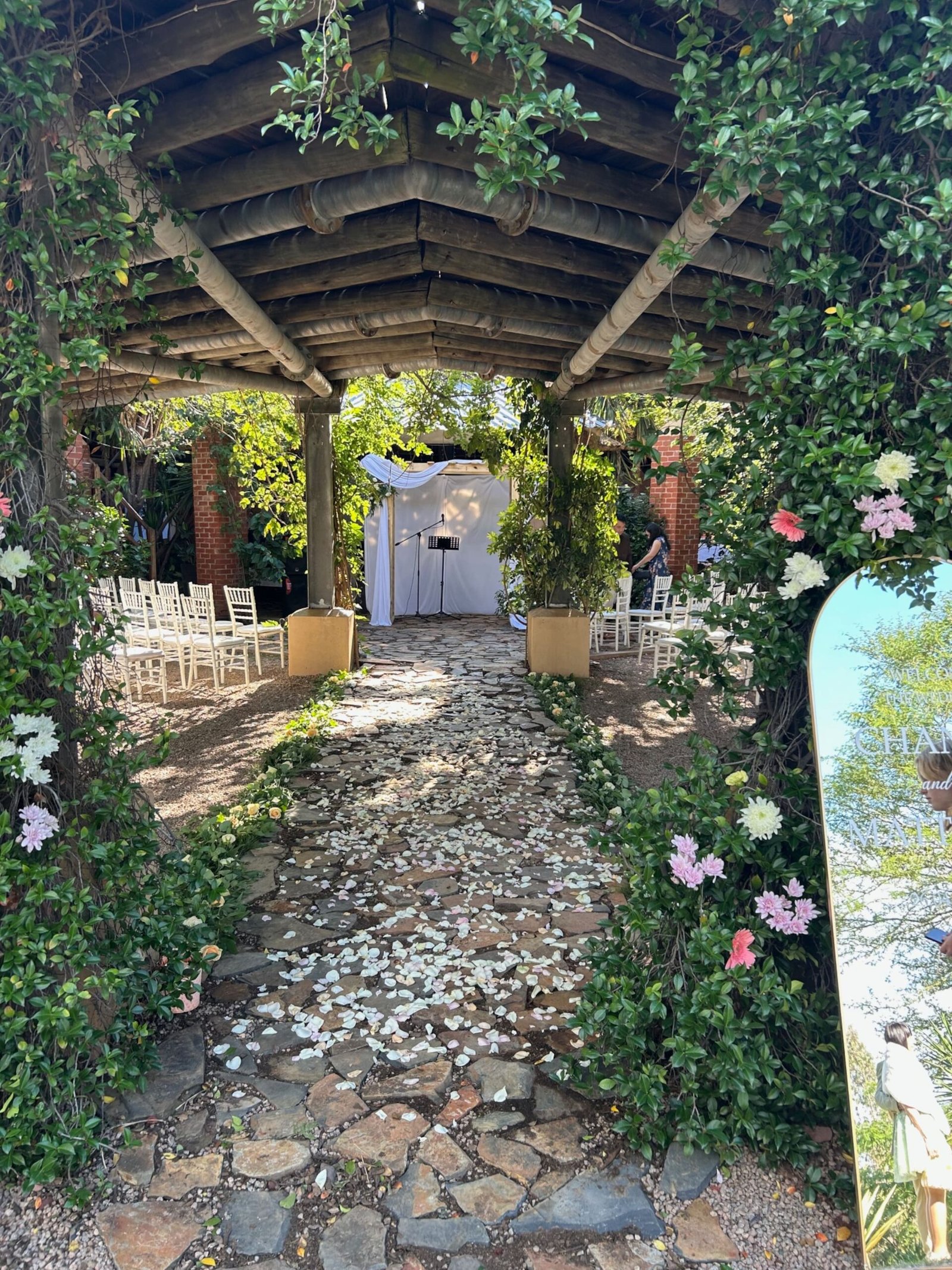 Rose arch walkway leading to the ceremony